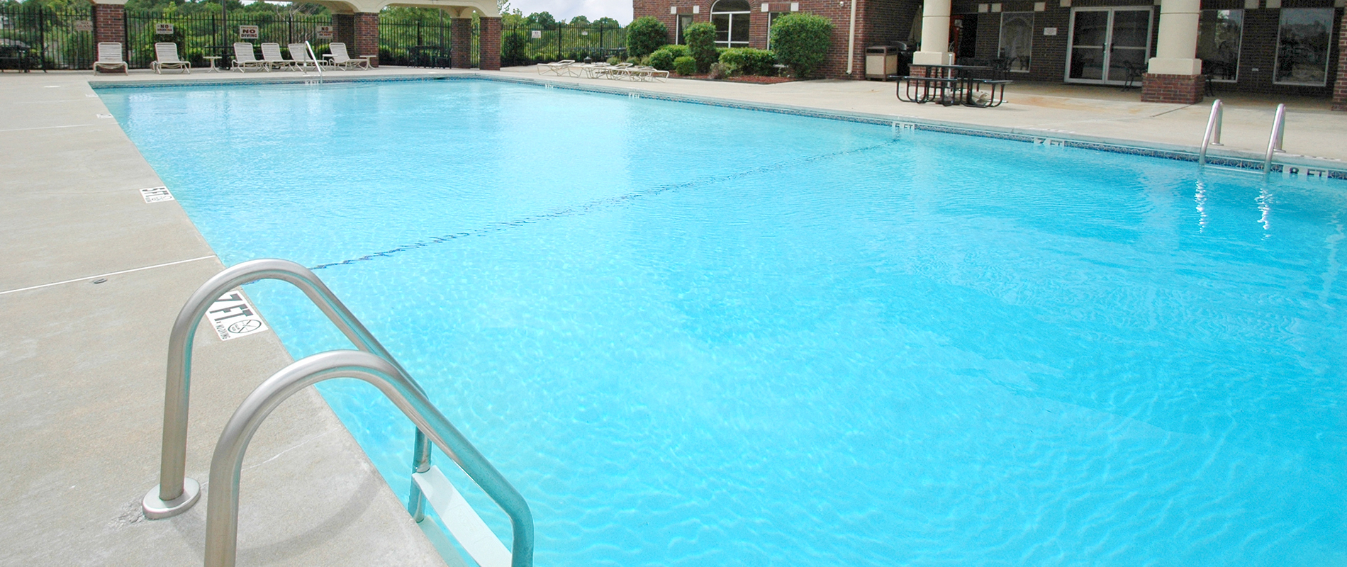 A swimming pool with a metal handrail.